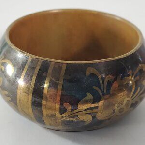Vintage Two-toned Brass Bangle Bracelet with Floral Design on Black Background